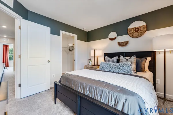 a bedroom with a bed and painting on the wall