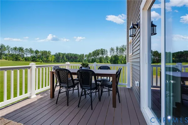 a view of a dinning table and chairs on deck with wooden floor