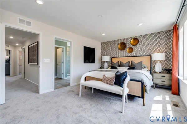 a bedroom with a bed and a painting on the wall