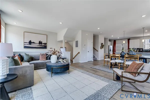 a living room with furniture and kitchen view
