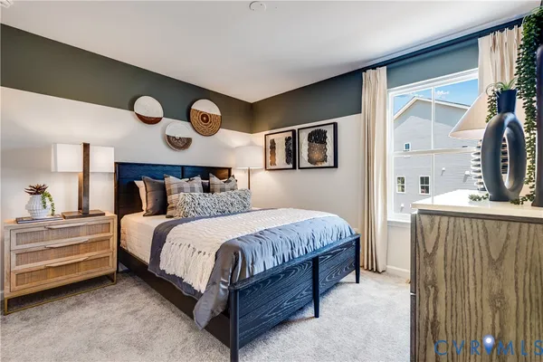 a bedroom with a bed and painting on the wall