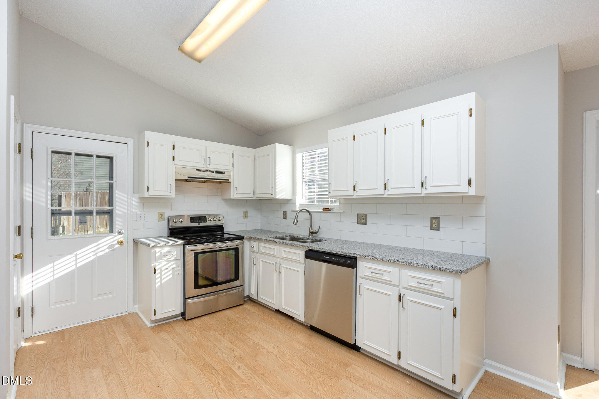 2108 Carthage Circle Raleigh, NC 27604 - Photo 11 of 27 a kitchen with granite countertop white cabinets and white appliances