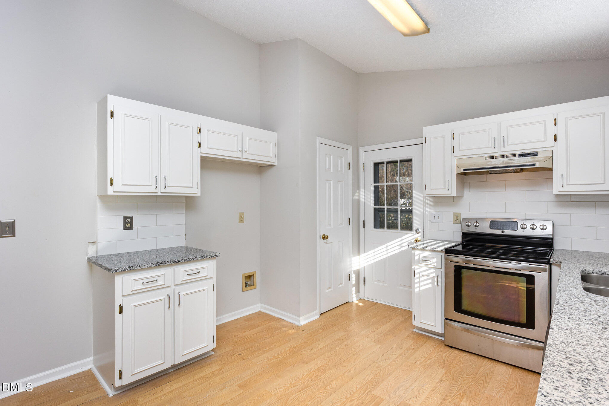 2108 Carthage Circle Raleigh, NC 27604 - Photo 12 of 27 a kitchen with white cabinets and appliances