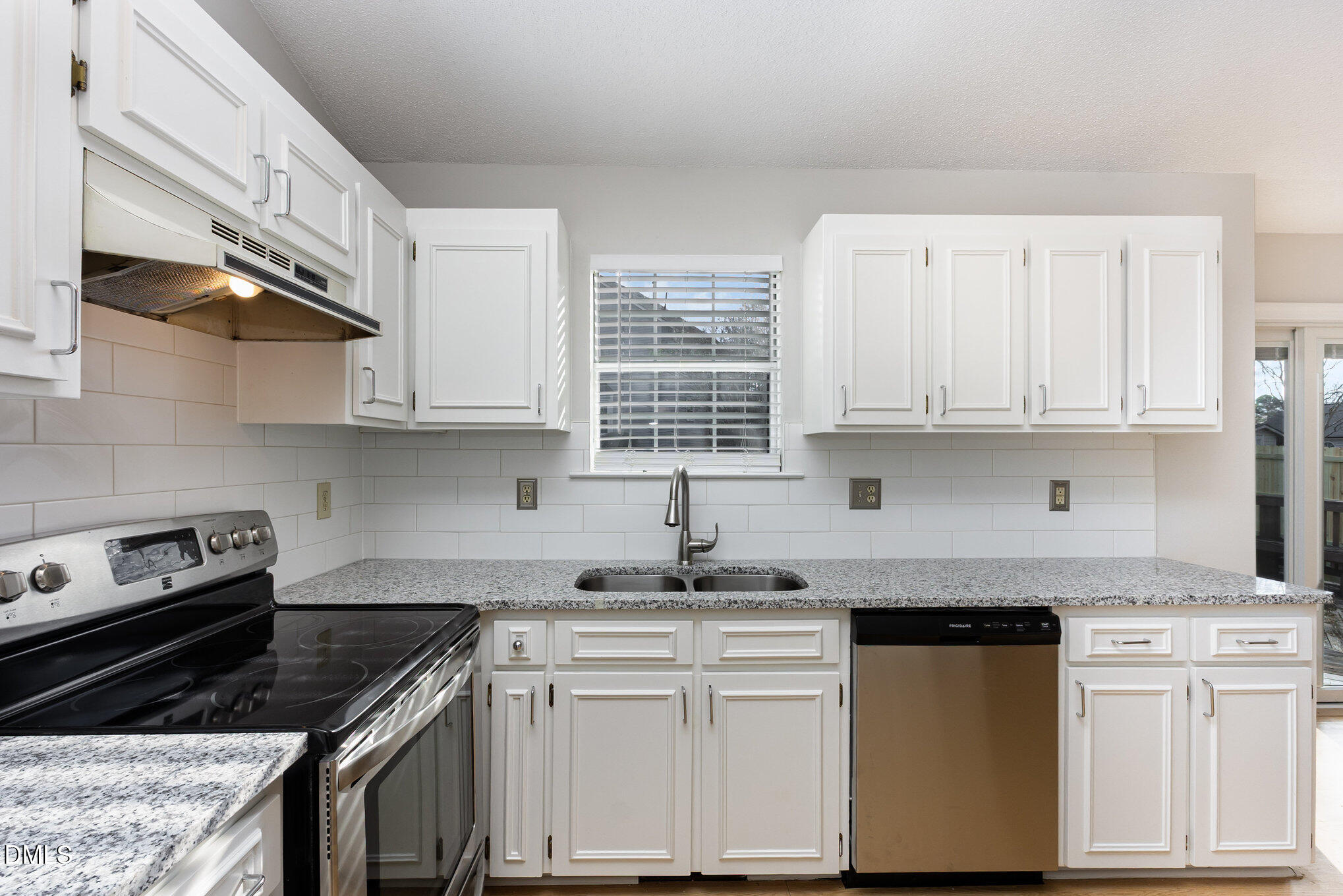 2108 Carthage Circle Raleigh, NC 27604 - Photo 13 of 27 a kitchen with white cabinets and appliances