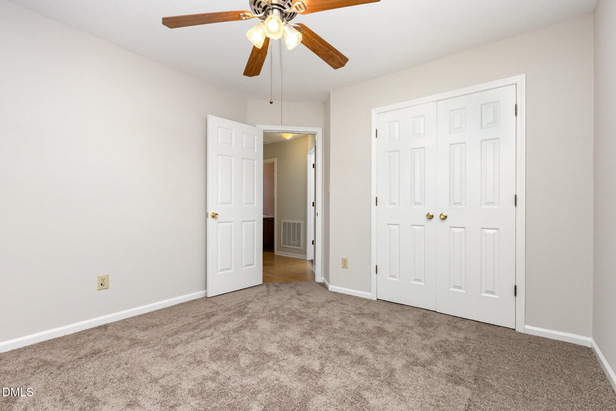 2108 Carthage Circle Raleigh, NC 27604 - Photo 18 of 27 an empty room with closet and a chandelier fan