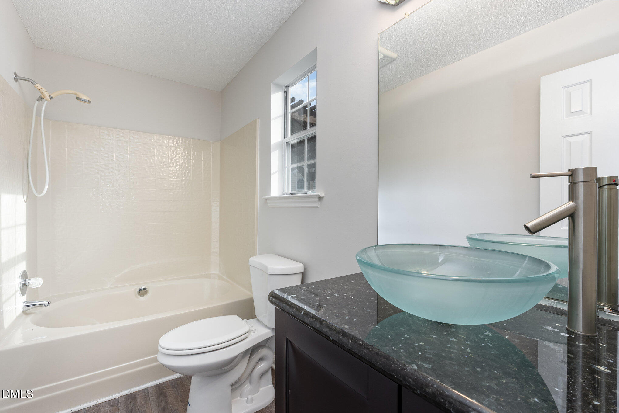 2108 Carthage Circle Raleigh, NC 27604 - Photo 22 of 27 a bathroom with a granite countertop sink and a mirror