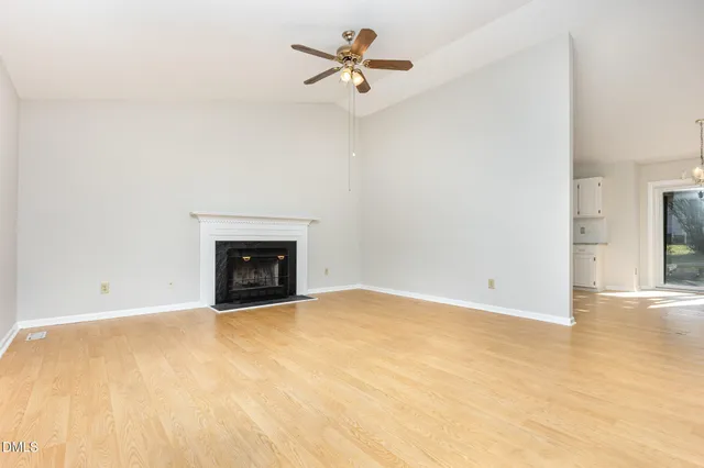a view of an empty room with a fireplace
