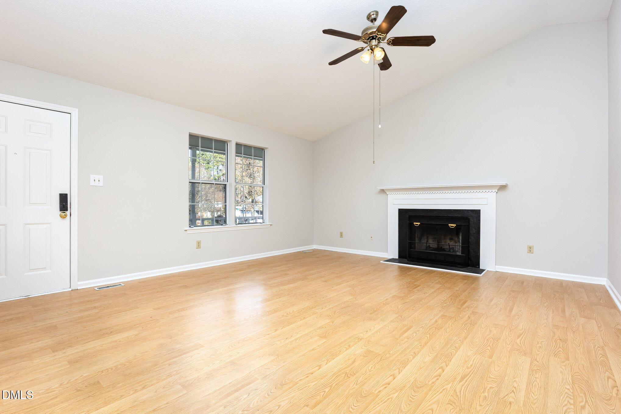 2108 Carthage Circle Raleigh, NC 27604 - Photo 6 of 27 a view of an empty room with a fireplace and a window