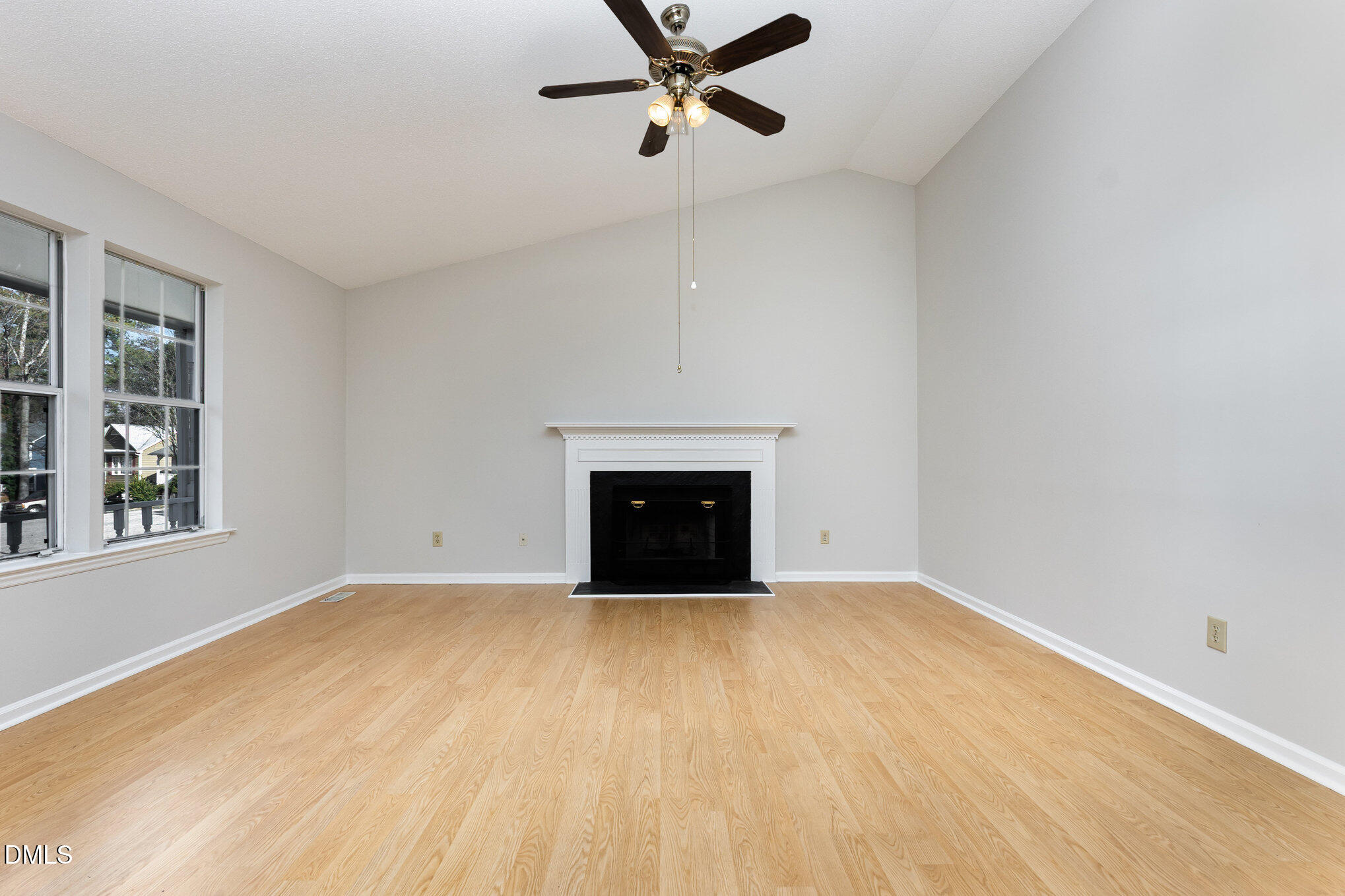 2108 Carthage Circle Raleigh, NC 27604 - Photo 7 of 27 wooden floor in an empty room with a fireplace