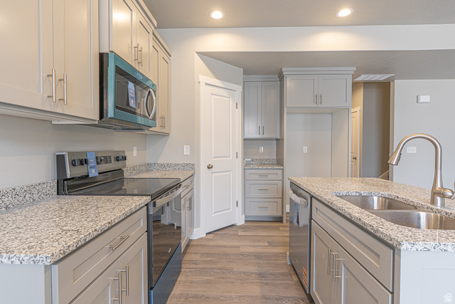 2257 South 1090 West, Unit 74 Nibley, UT 84321 - Photo 1 of 40 Modern kitchen featuring light gray cabinetry, granite countertops, and wood-finish flooring