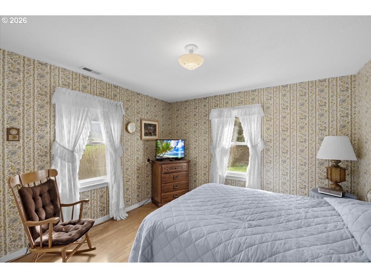 2277 Cougar Creek Road Oakland, OR 97462 - Photo 14 of 34 a bedroom with a bed window and chair