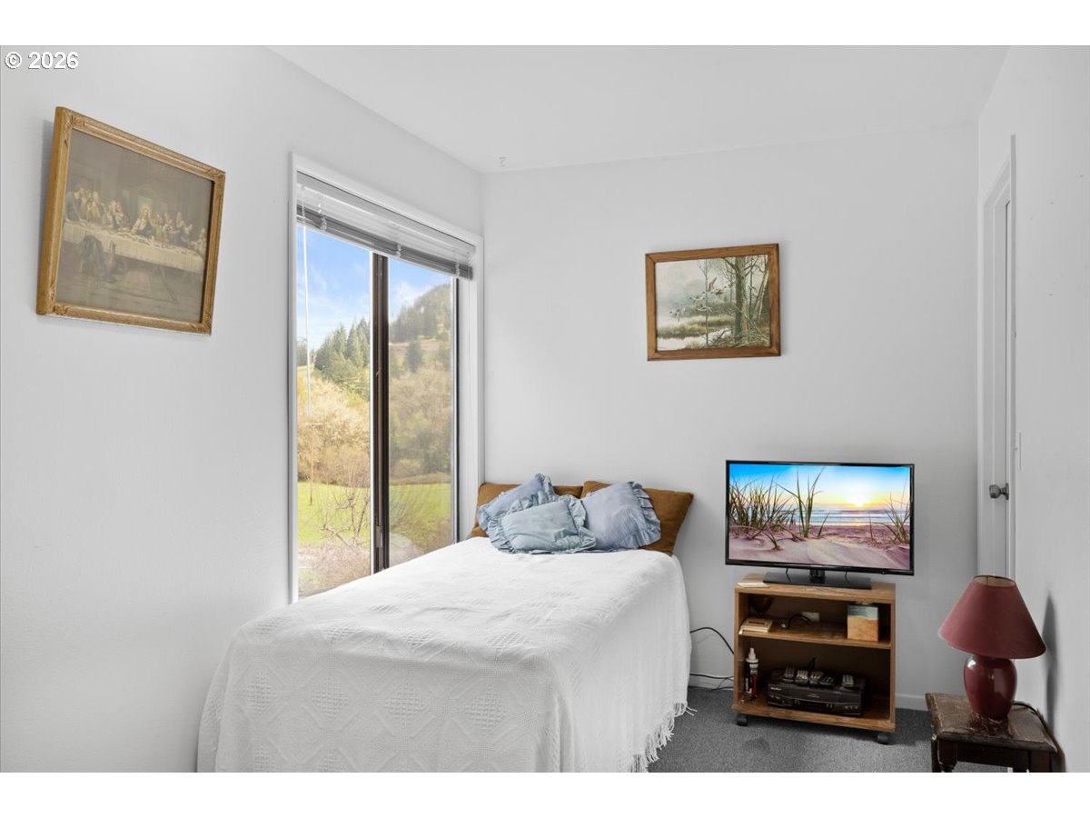 2277 Cougar Creek Road Oakland, OR 97462 - Photo 19 of 34 a bedroom with furniture and wooden floor