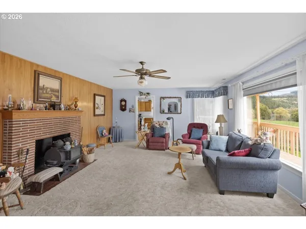 a view of a dining room with furniture a chandelier and wooden floor