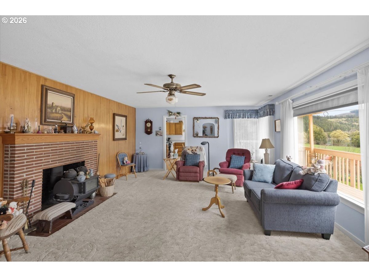 2277 Cougar Creek Road Oakland, OR 97462 - Photo 8 of 34 a living room with furniture and a fireplace