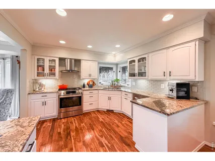 a living room with furniture and view of kitchen