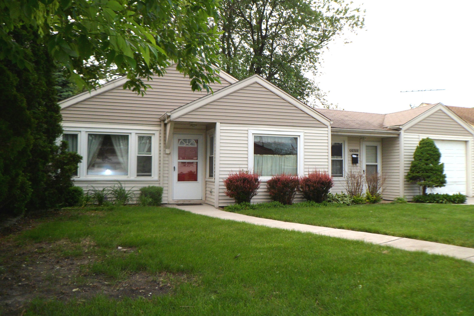 10708 Princess Avenue Chicago Ridge, IL 60415 - Photo 1 of 16 a front view of a house with a garden and yard