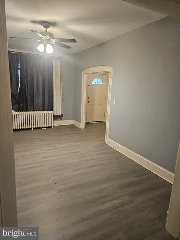 a view of a room with wooden floor