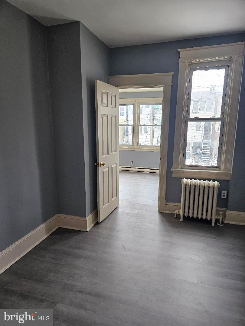 825 Delafield Place Northwest Washington, DC 20011 - Photo 23 of 25 an empty room with wooden floor and windows