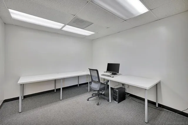 a view of a bedroom with baby crib and a window