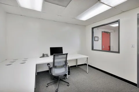 a view of a workspace with furniture