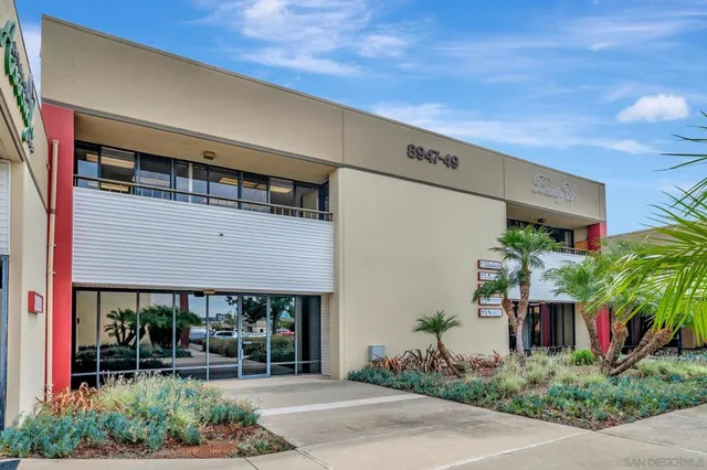a front view of house with green space
