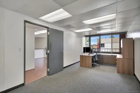 a workspace with furniture and a window