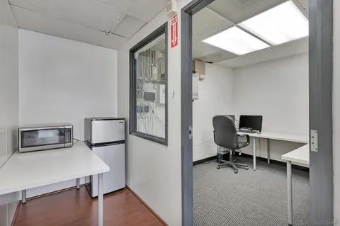 an empty room with wooden floor and mirror