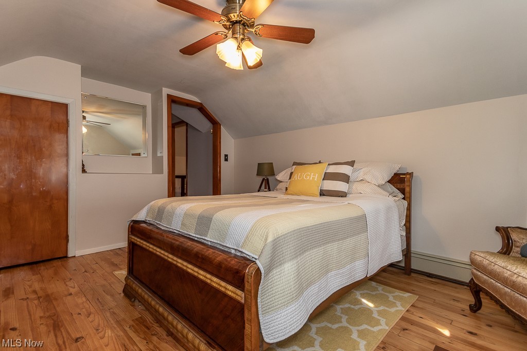 1318 Sunset Road Cleveland, OH 44124 - Photo 22 of 29 Bedroom featuring light hardwood / wood-style flooring, baseboard heating, ceiling fan, and vaulted ceiling