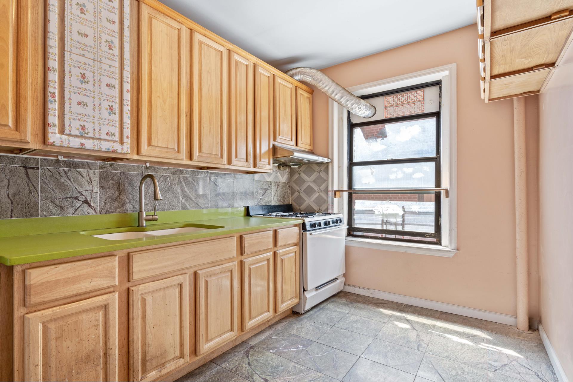 a kitchen with stainless steel appliances granite countertop a sink and cabinets with wooden floor