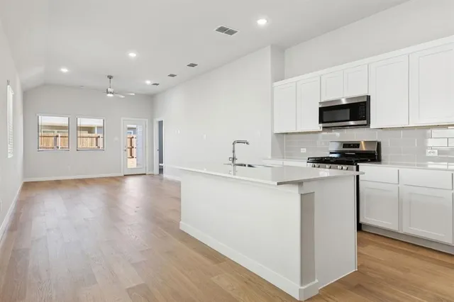 a view of a house with a yard and a garden
