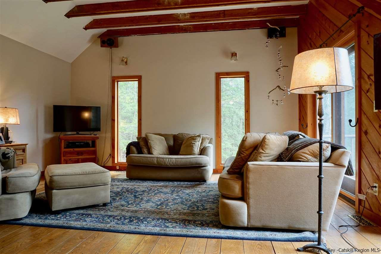 115 Woodland Road Stone Ridge, NY 12484 - Photo 8 of 34 a living room with furniture and a flat screen tv