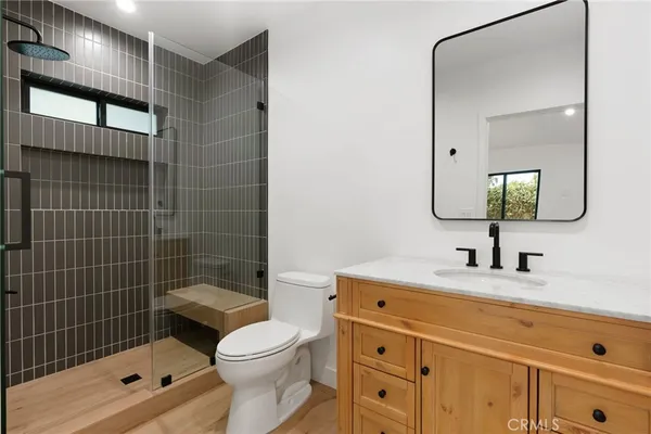a bathroom with a sink a toilet and shower