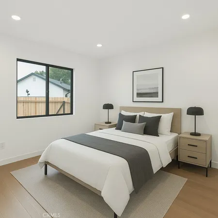 a bedroom with a bed and a painting on the wall