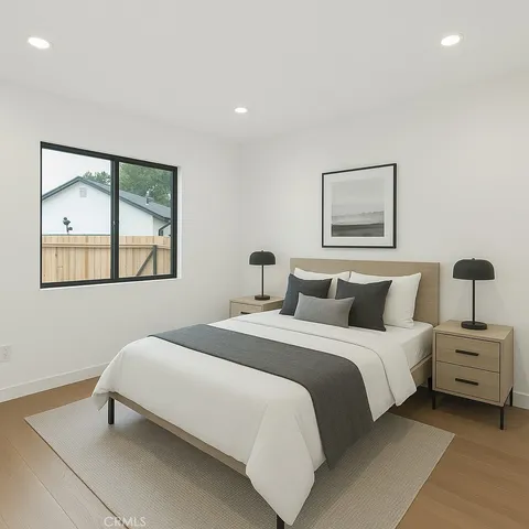 a bedroom with a bed and a painting on the wall