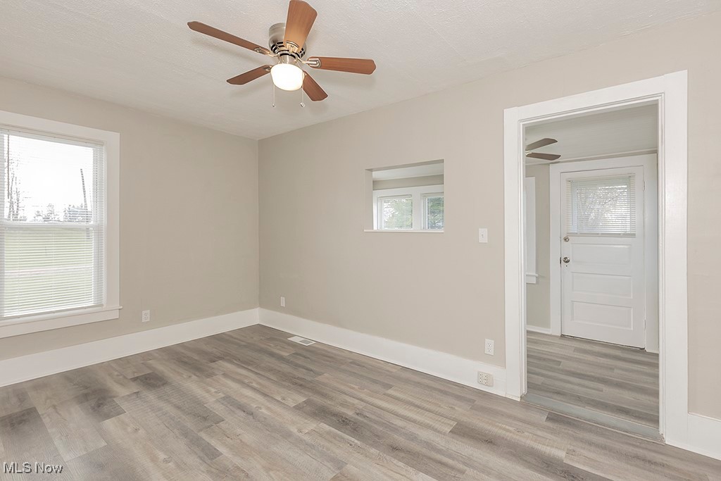 12447 Chillicothe Road Chesterland, OH 44026 - Photo 29 of 42 Unfurnished room with ceiling fan, a textured ceiling, and light hardwood / wood-style flooring