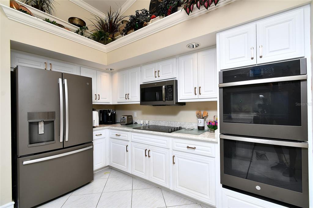 6030 Key Largo Circle Punta Gorda, FL 33955 - Photo 13 of 44 a kitchen with stainless steel appliances a stove a microwave and a refrigerator