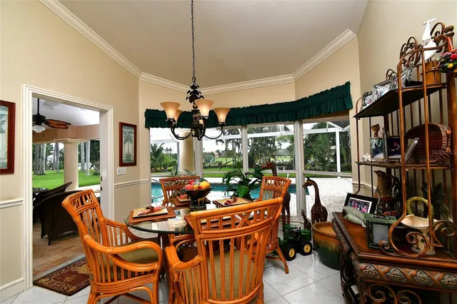a view of a dining room with furniture wooden floor and chandelier