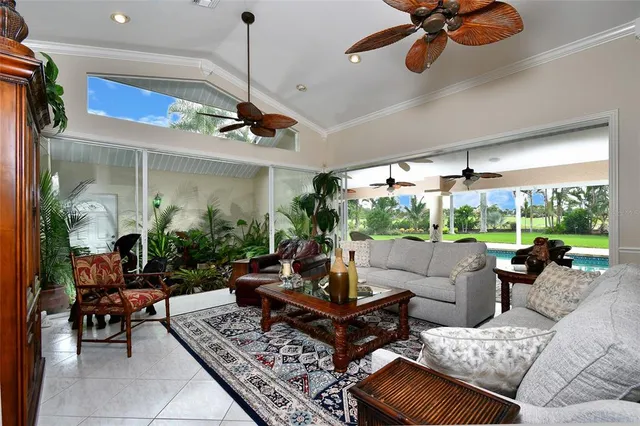 a living room with patio furniture and a potted plant