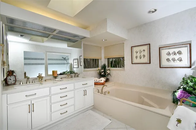 a bath tub sitting next to a white sink