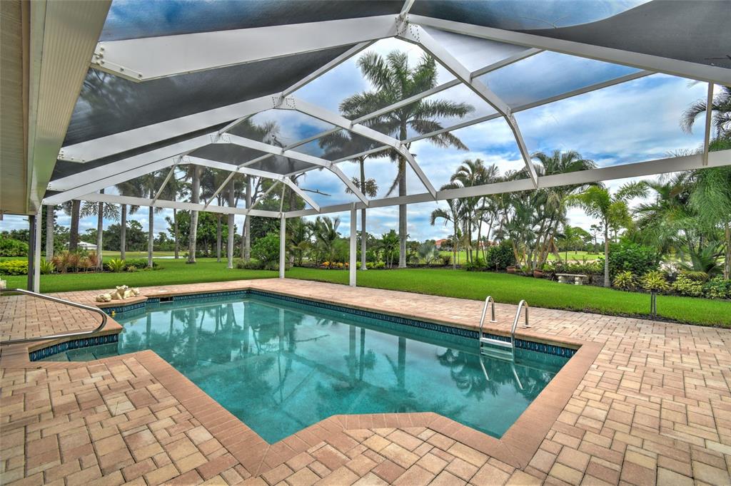 6030 Key Largo Circle Punta Gorda, FL 33955 - Photo 36 of 44 a view of a swimming pool with a yard