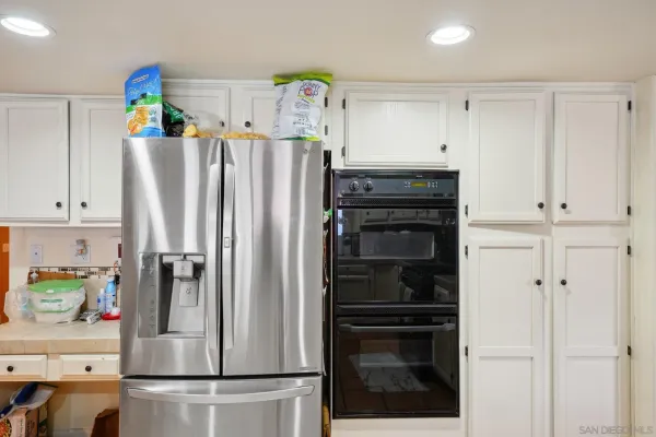 a kitchen with stainless steel appliances a refrigerator and cabinets