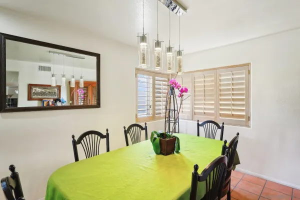 a view of a dining room with furniture and chandelier