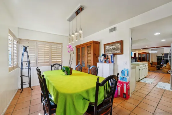 a view of a dining room with furniture and a chandelier
