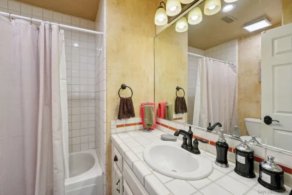 a bathroom with a tub sink and mirror