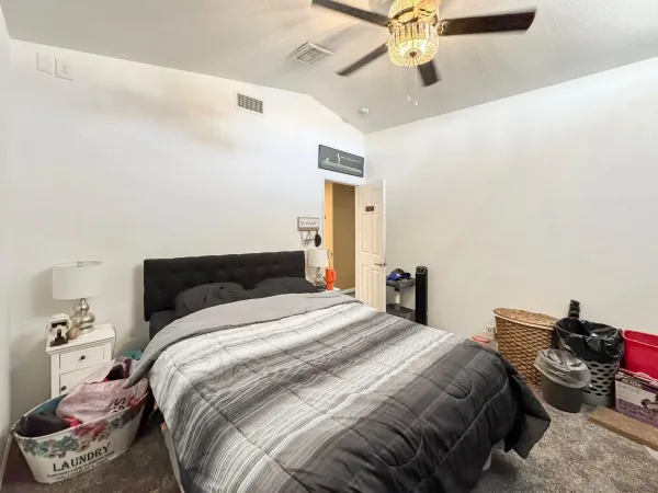 a bedroom with a bed and a chandelier
