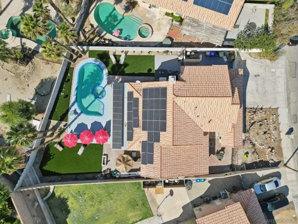 an aerial view of residential houses with outdoor space and street view