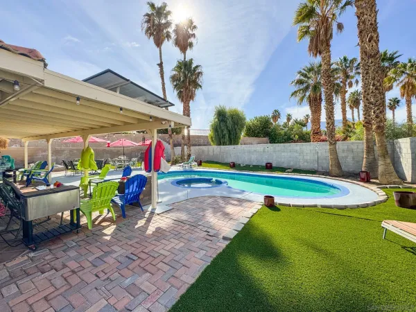 a view of a backyard with swimming pool