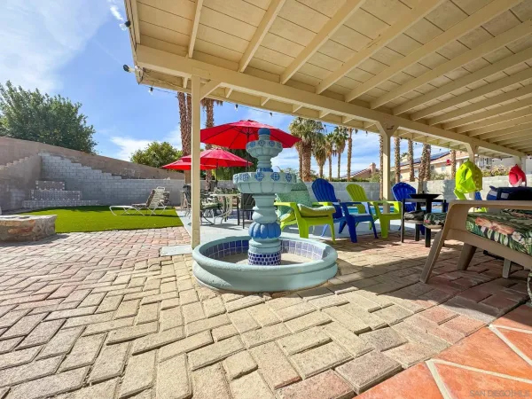 a building outdoor space with patio furniture and potted plants