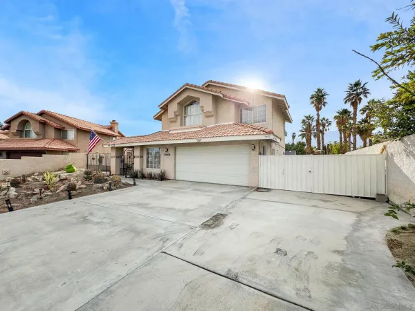 a view of a house with a wooden fence