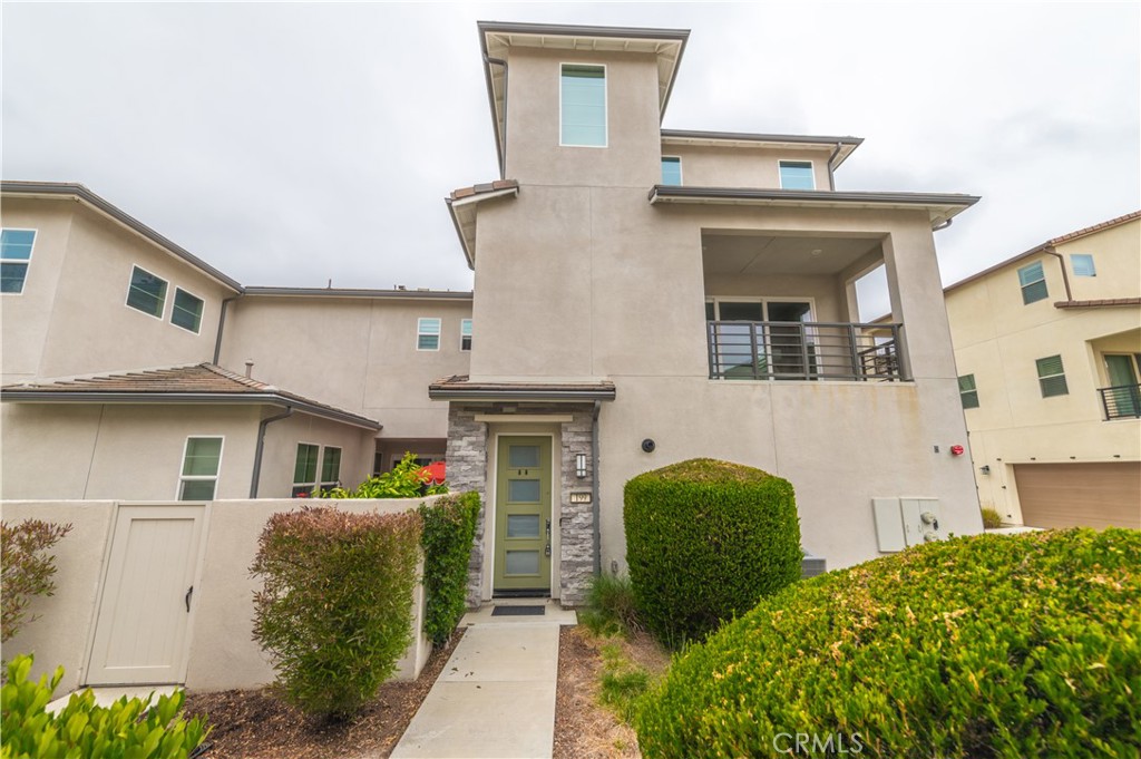 199 Frame Irvine, CA 92618 - Photo 1 of 1 a view of a white house with large windows and a table and chairs